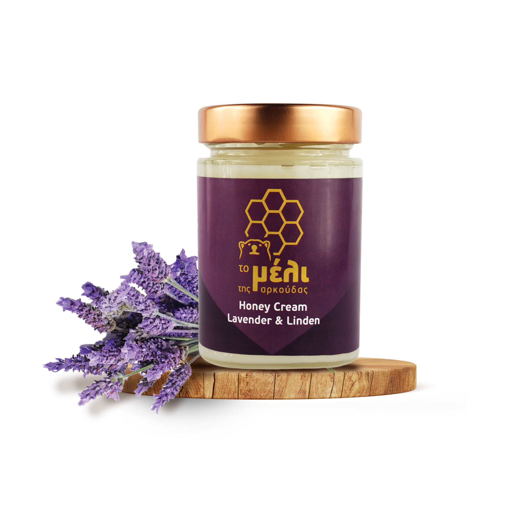 Ein Glas Honigcreme aus Lavendel und Lindenblüten auf einem Holzbrett neben einem Lavendelzweig